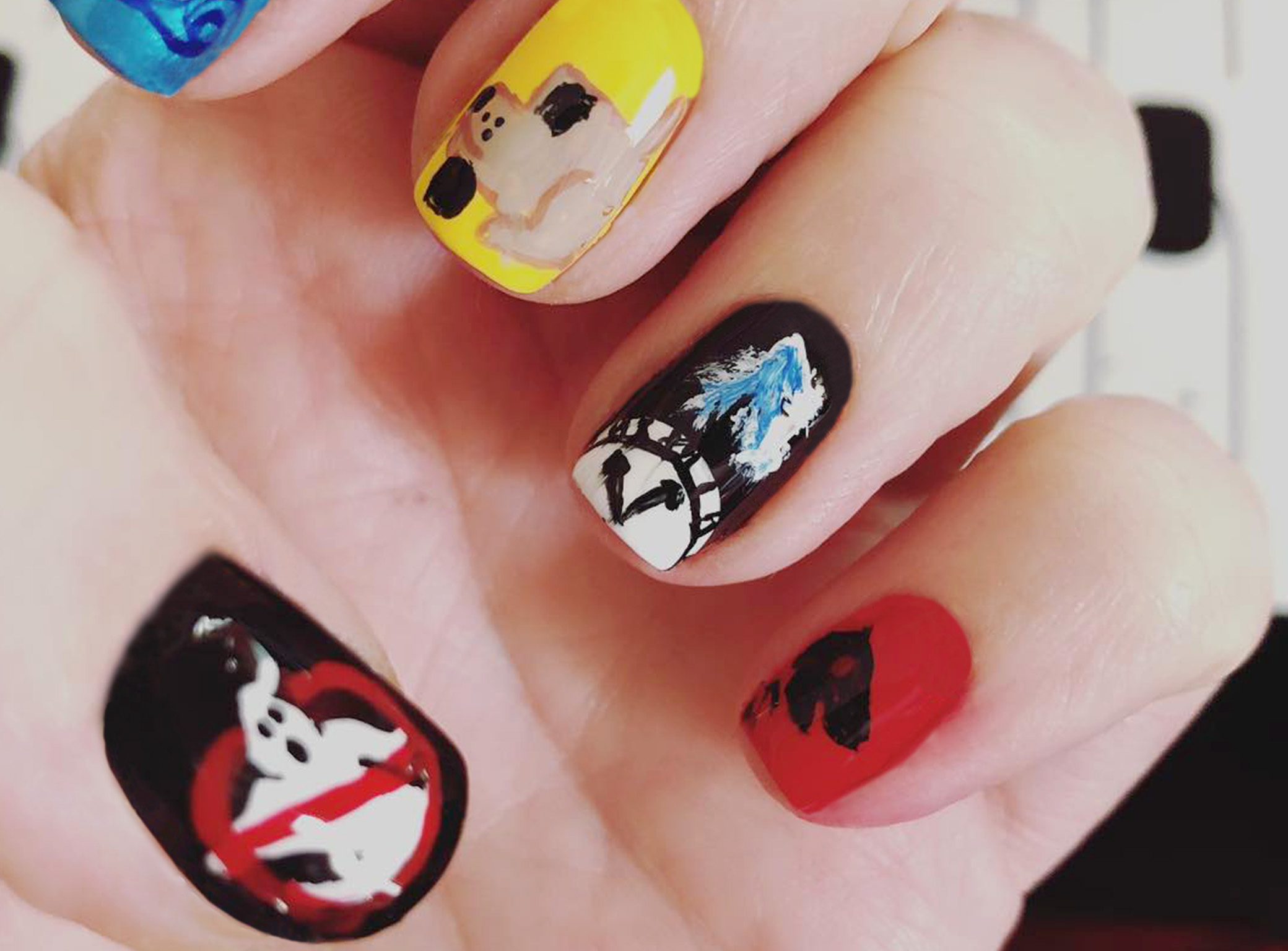 Some of Jenna Sundeen's fingernail masterpieces: Ghostbusters logo, clock, dog.