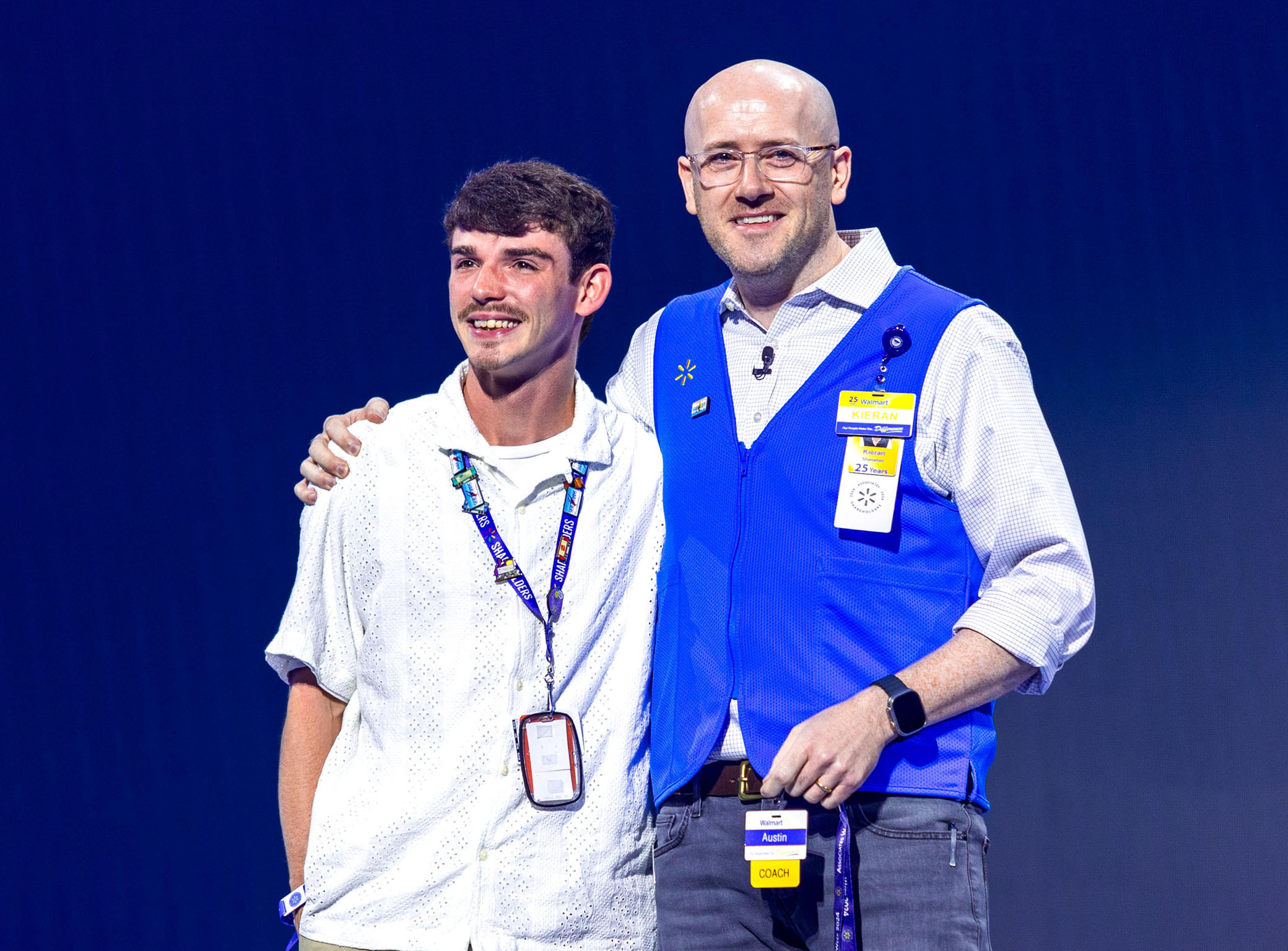 Kieran and associate on stage smiling