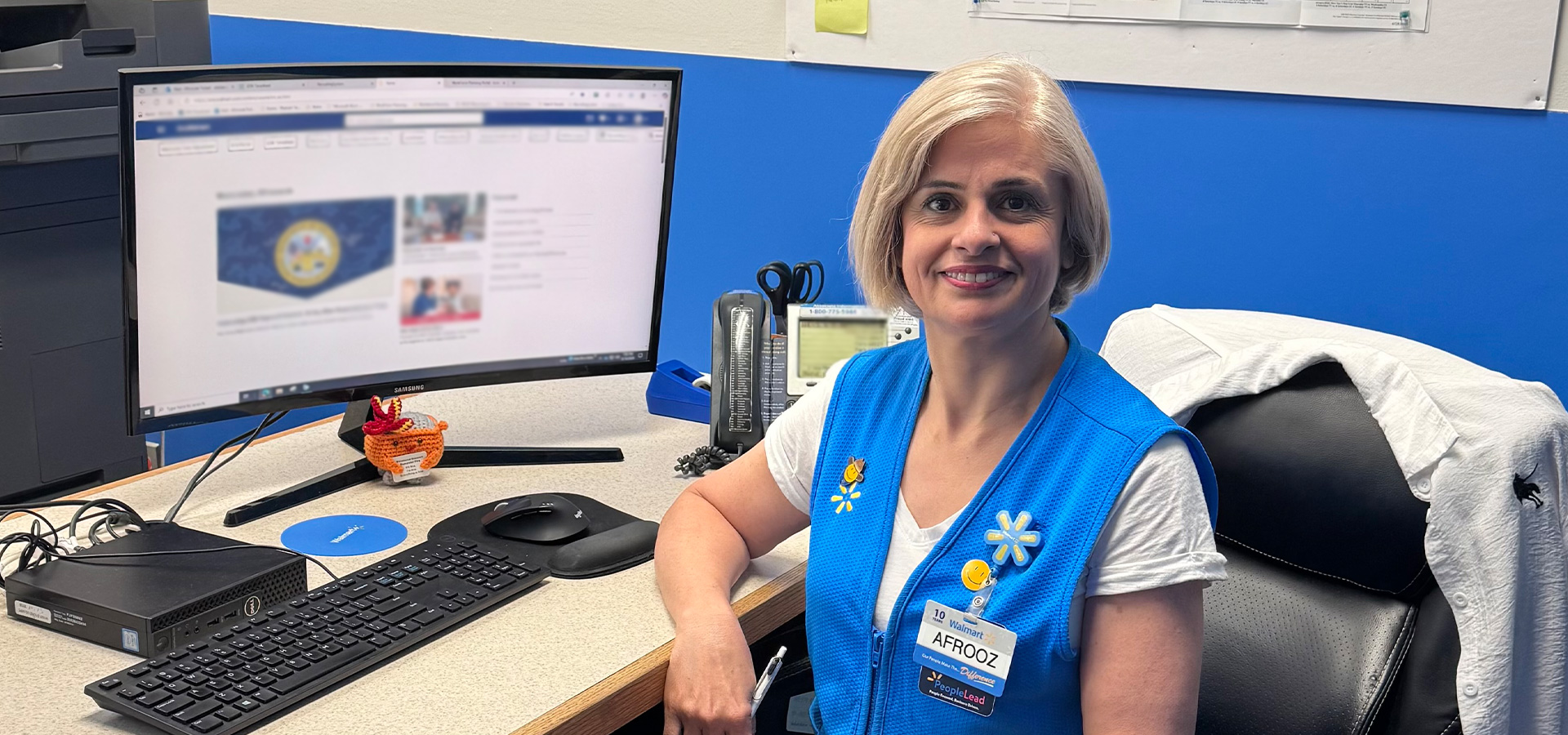 Walmart associate Afroozak Fadaei sits at her desk at Store 1827.