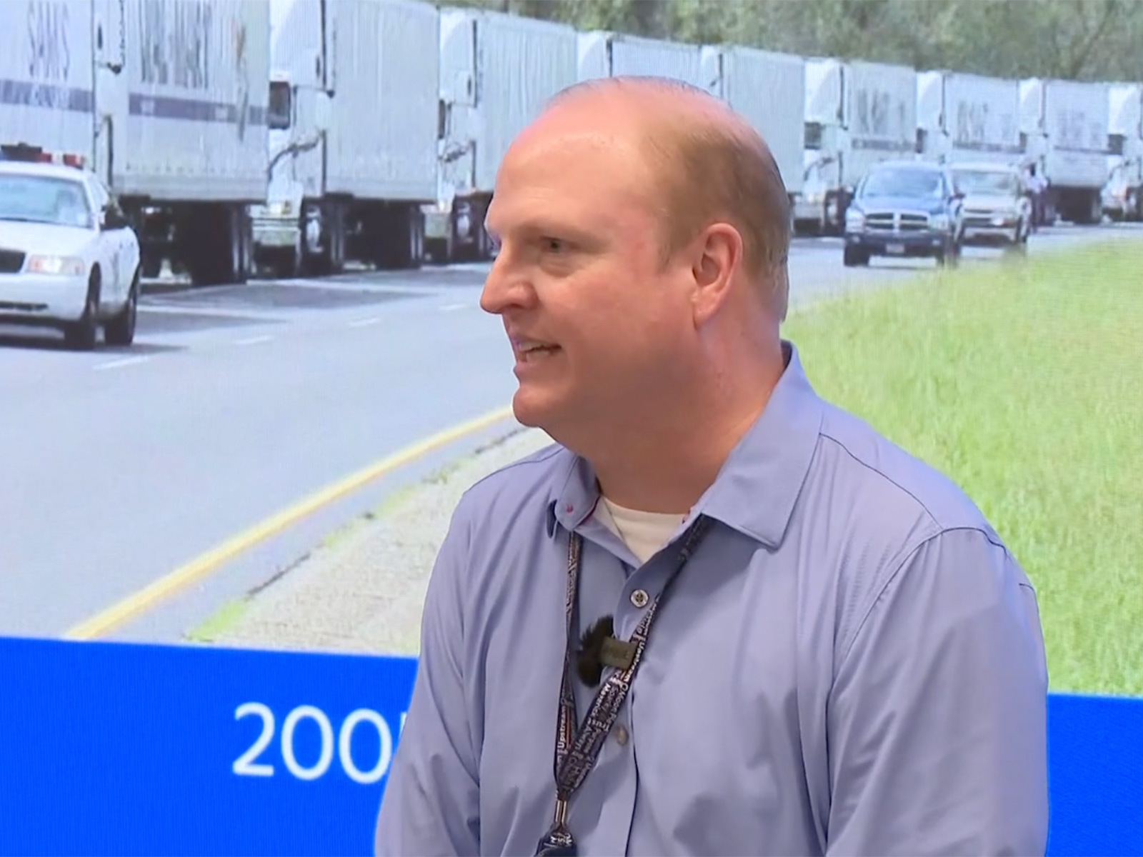 Lee Siler talks about Walmart's new Global Security Operations Center in front of a mural of Walmart's response to Hurricane Katrina.