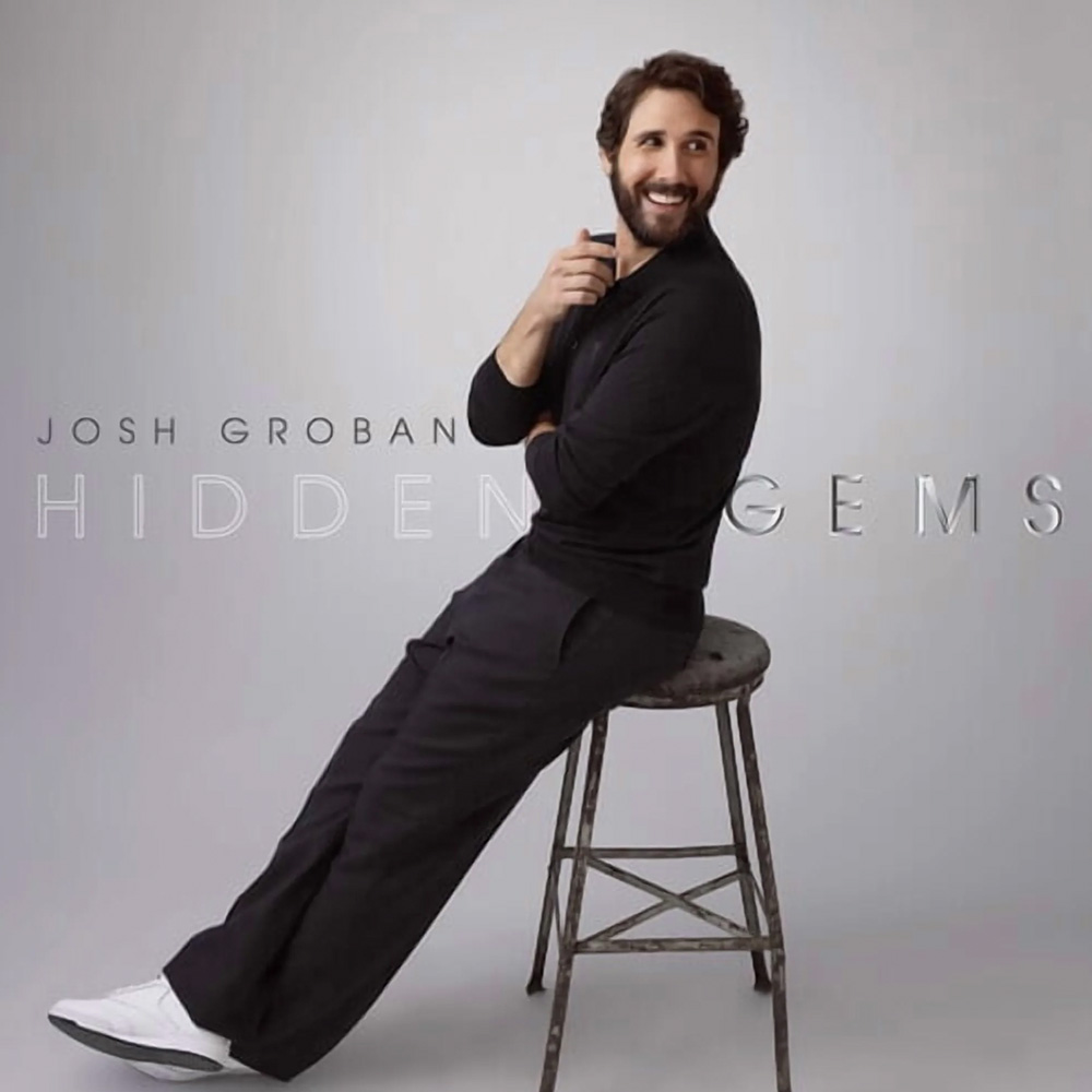 Josh Groban, dressed in black attire, is seated on a metal stool against a neutral background. The text 'Josh Groban' and 'Hidden Gems' is prominently displayed.