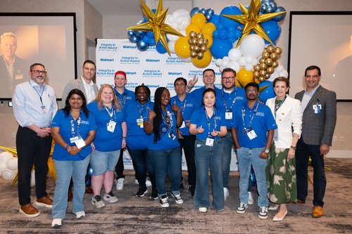 A diverse group of Walmart associates and leaders pose together at the Integrity in Action Award celebration.