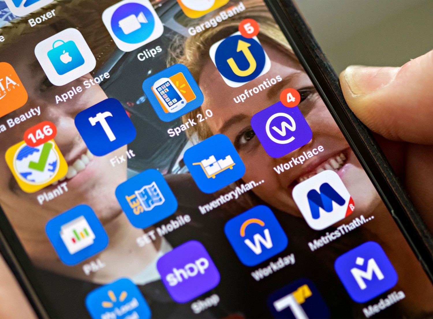 Image of phone showing gallery of work-related apps including Workplace.