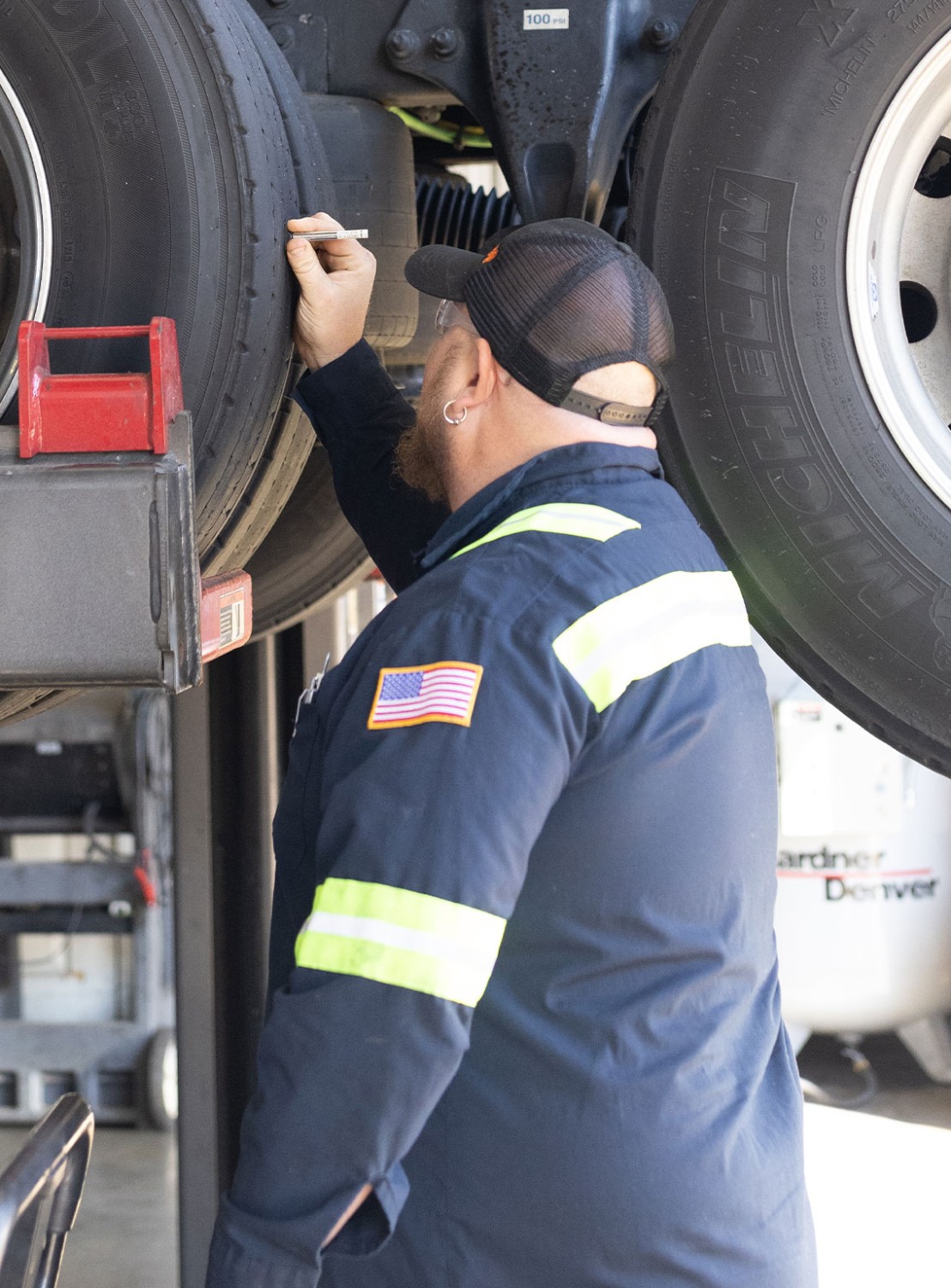 A technician inspects tires