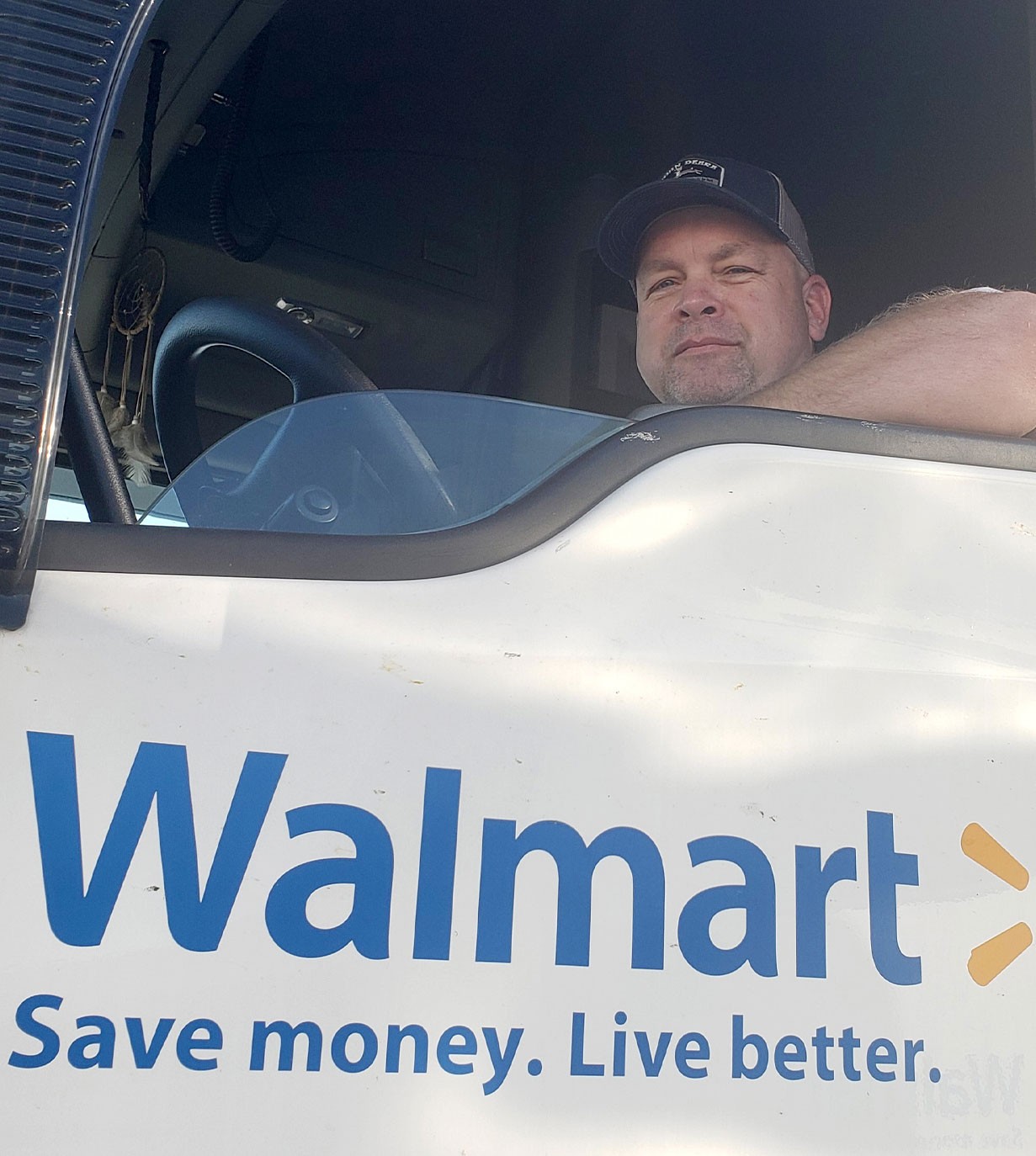 Rodney Obenshain smiles out the window of his rig