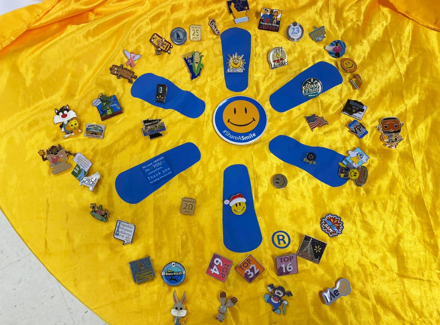 Eleanor Barnett decorated a yellow Walmart cape with multiple pins
