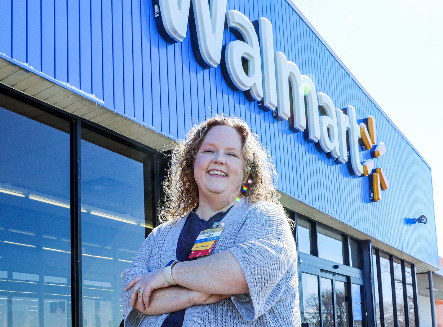 Store Manager Lisa Schmitt in front of Walmart Store 841 in Tipton, IA