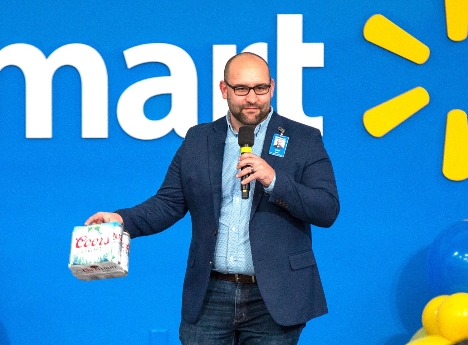 Cory Baker holds a six-pack of Coors beer that does not use plastic loop packaging.