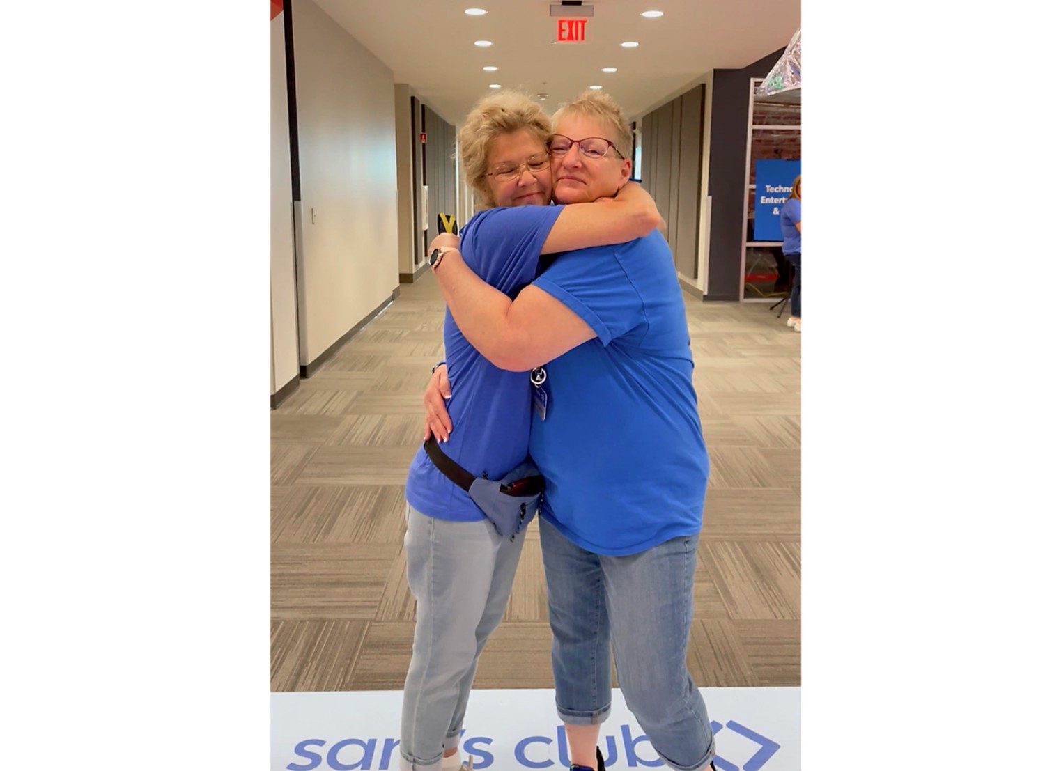 two women hugging and smiling at the camera