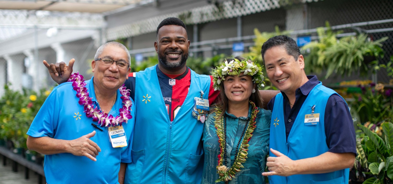 Group of diverse group of associates in front of the garden section of a Walmart store