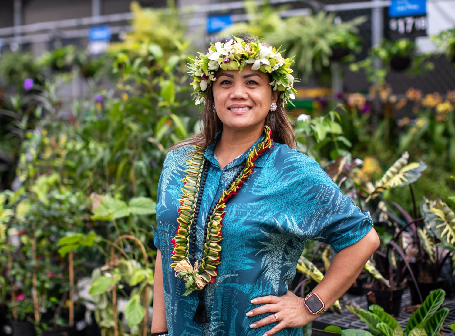 female associate smiling at the camera in the garden area of Walmart