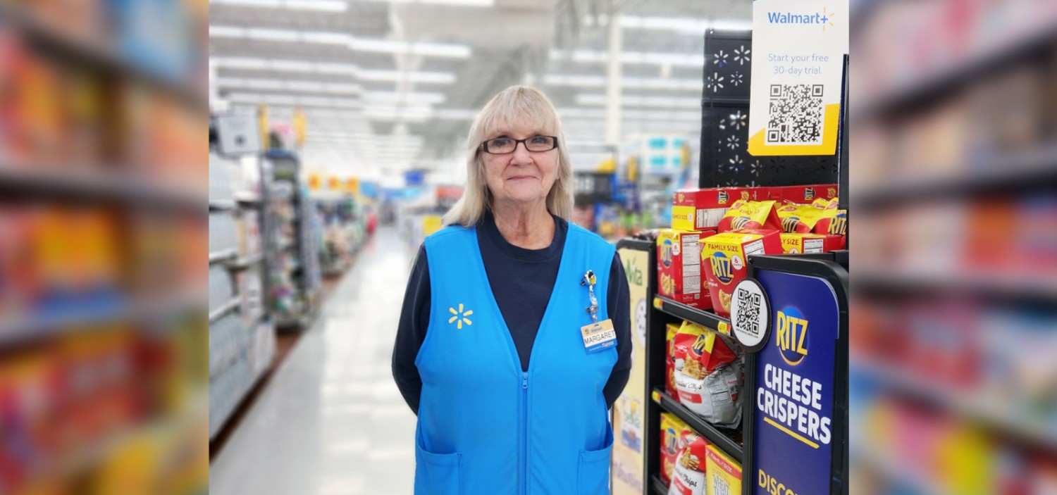 Margaret Bids standing in the aisle smiling at the camera