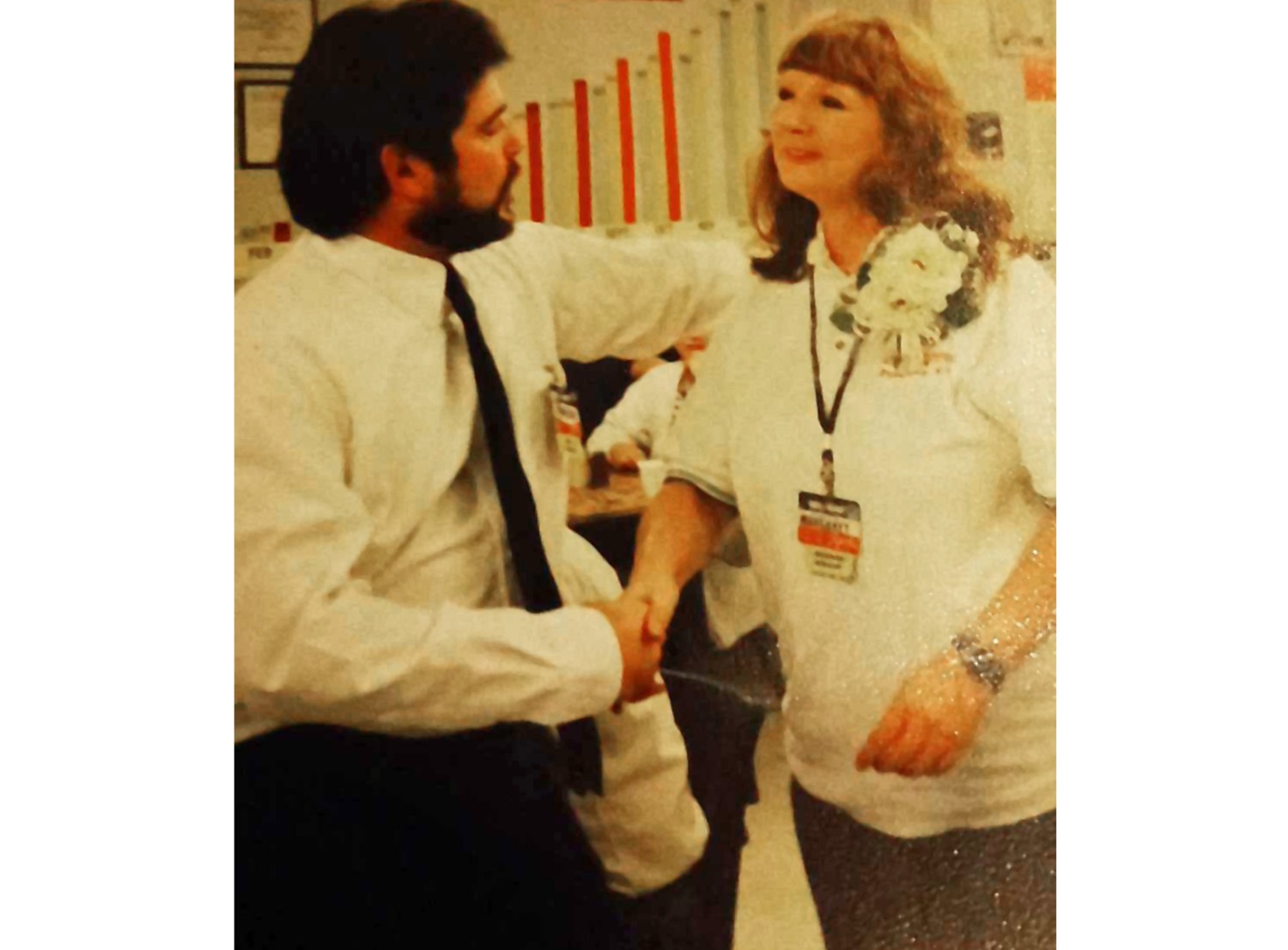 Margaret Bids and a male Walmart worker speaking to each other.