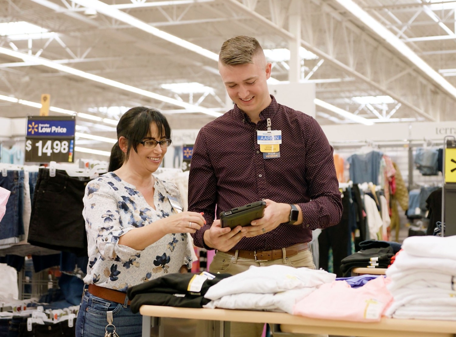 Aaron and a female associate in the clothing are of a Walmart store