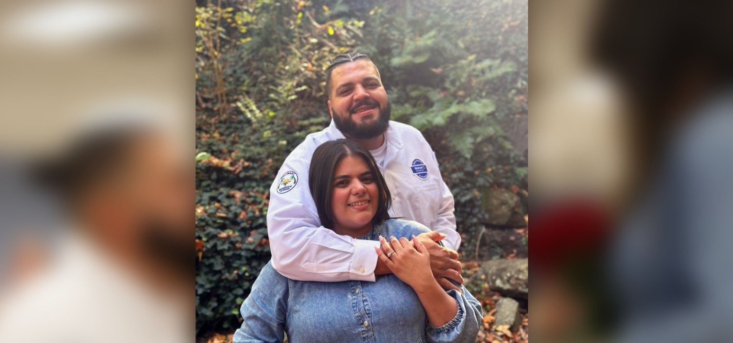 Erick and his fiancee smiling at the camera