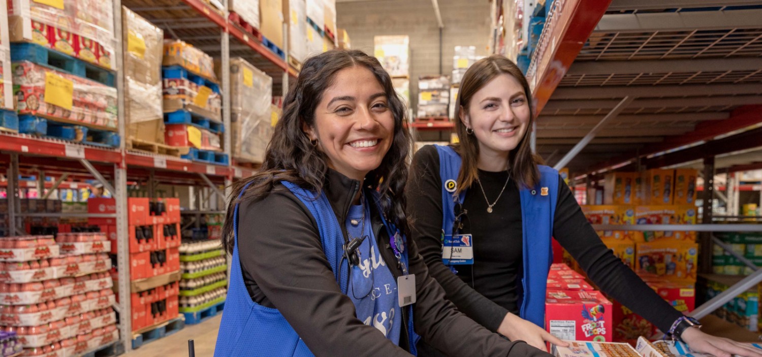 two female sam's club associates smiling at the camera