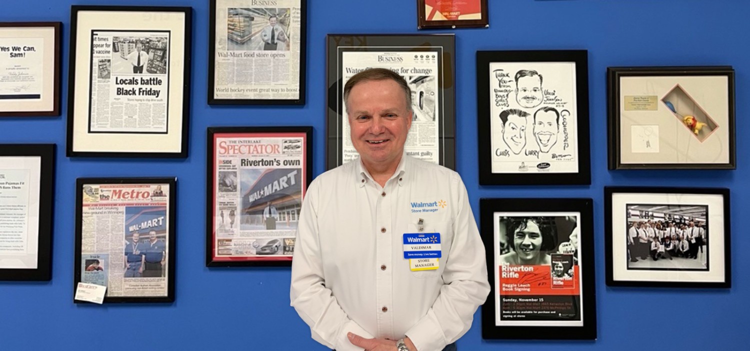 Valdimar standing in front of a wall of photo frames