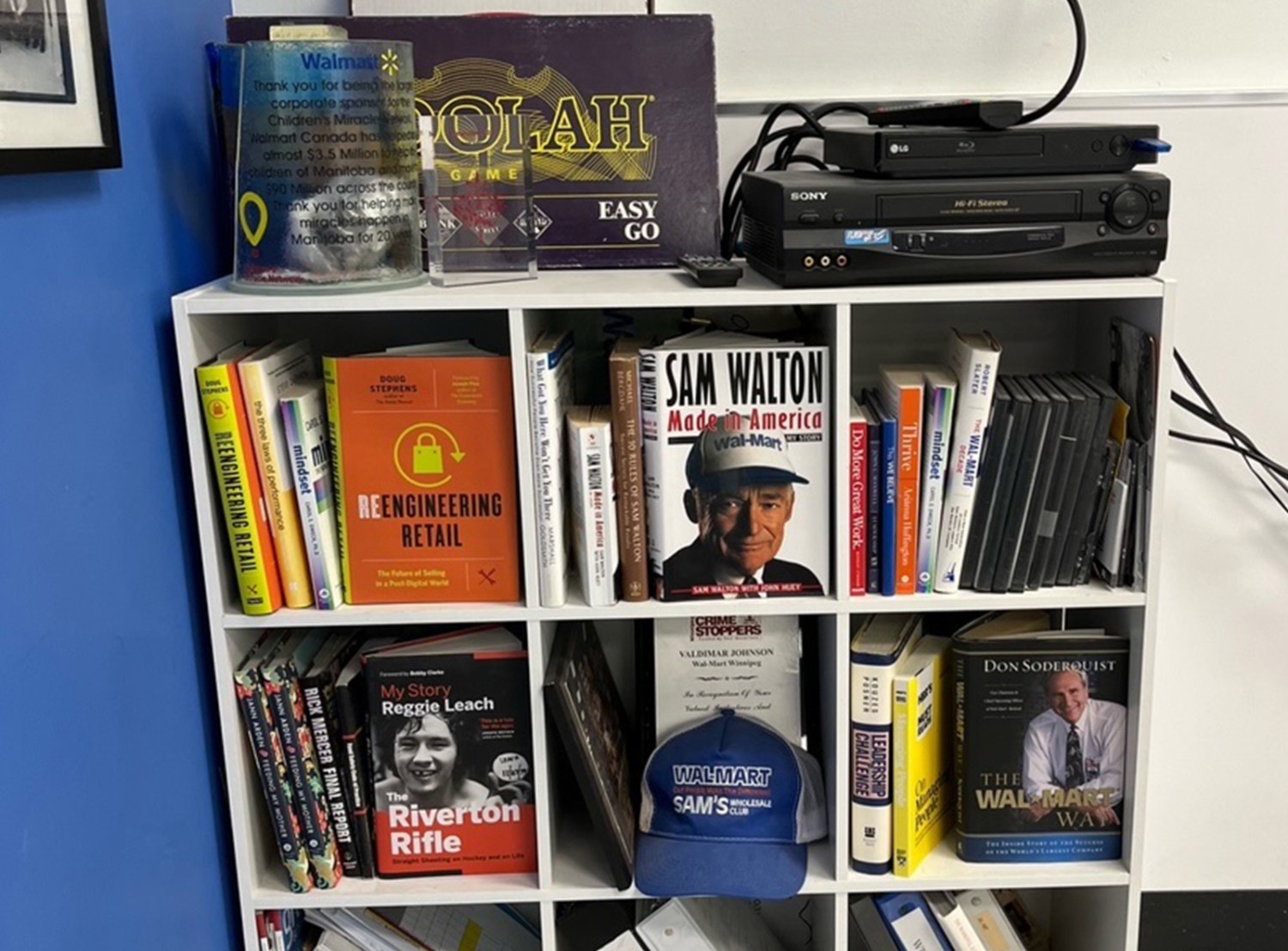 A collection of a books on a white bookshelf
