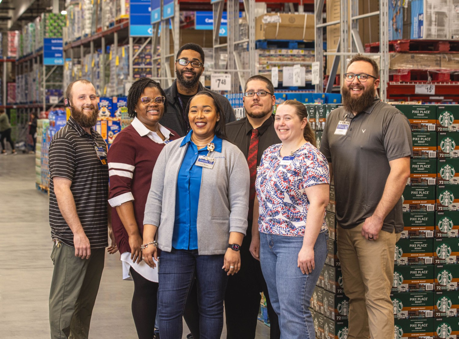 A diverse group of Sam's Club associates smiling at the camera