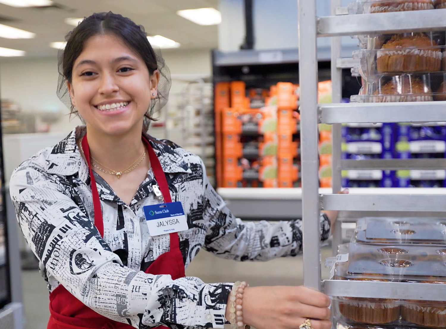 female Sam's Club associate with a bakery cart