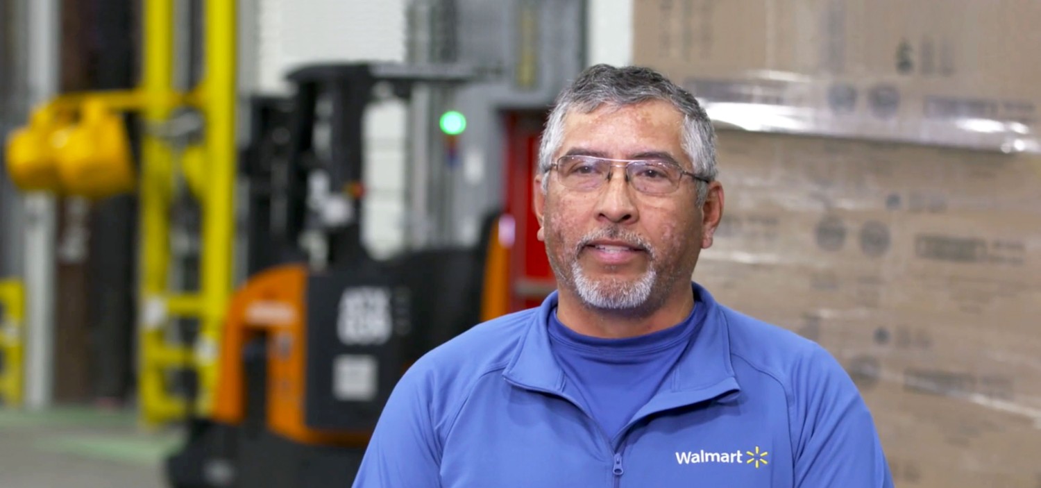 Jose Molina standing smiling at the camera at a fulfillment center
