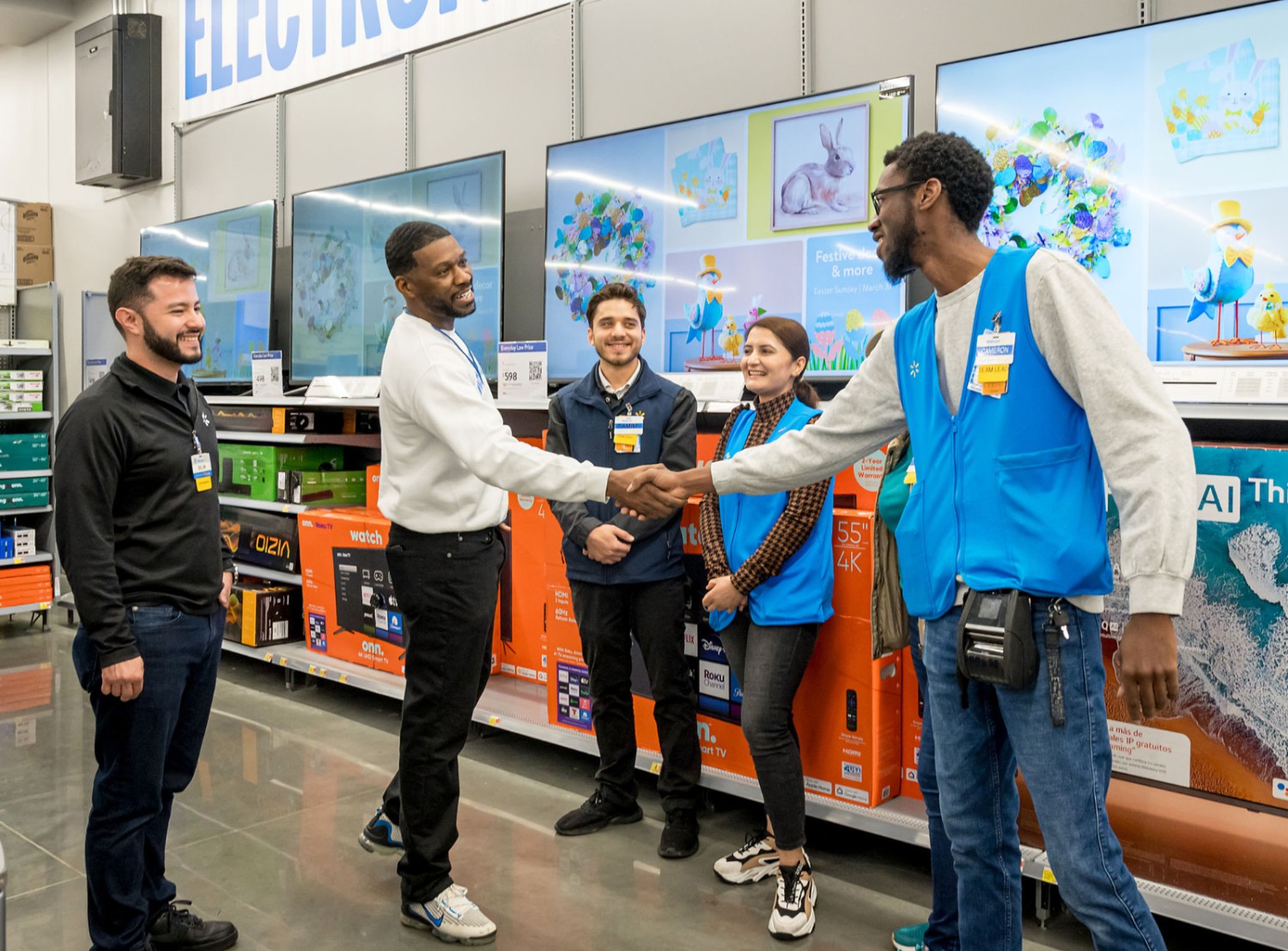 Wayne McFarland interacting with a diverse group of store associates