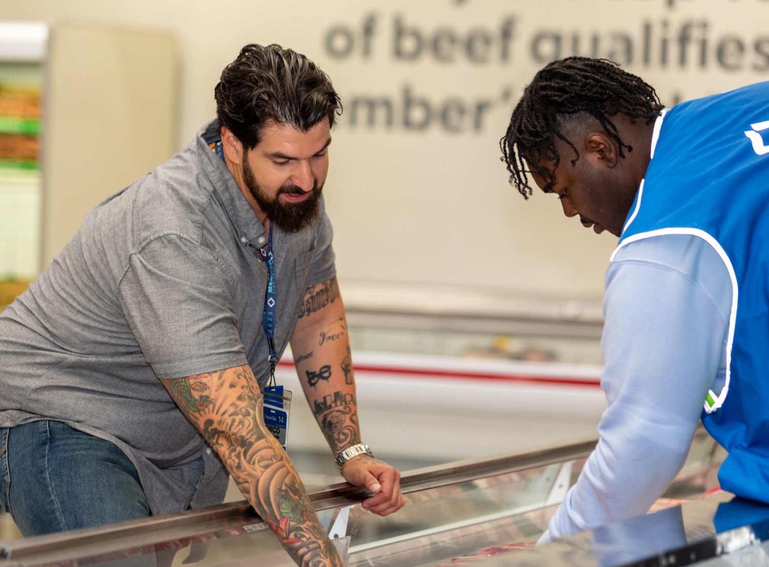 two male associates in the beef area of a Sam's Club