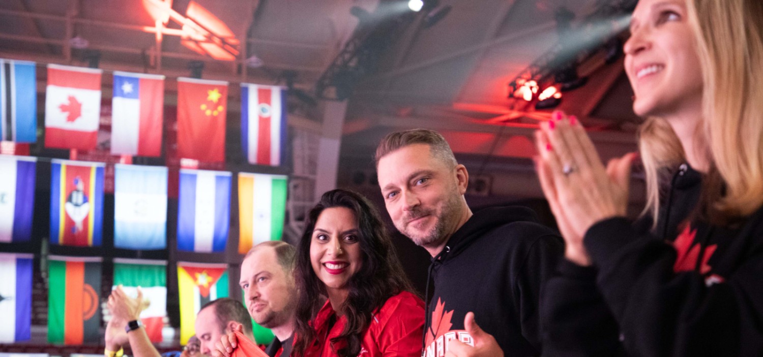a group of international associates smiling and clapping