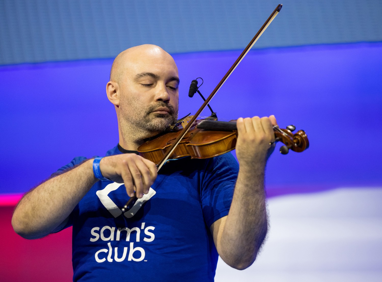 Nathan Dill playing the violin on stage