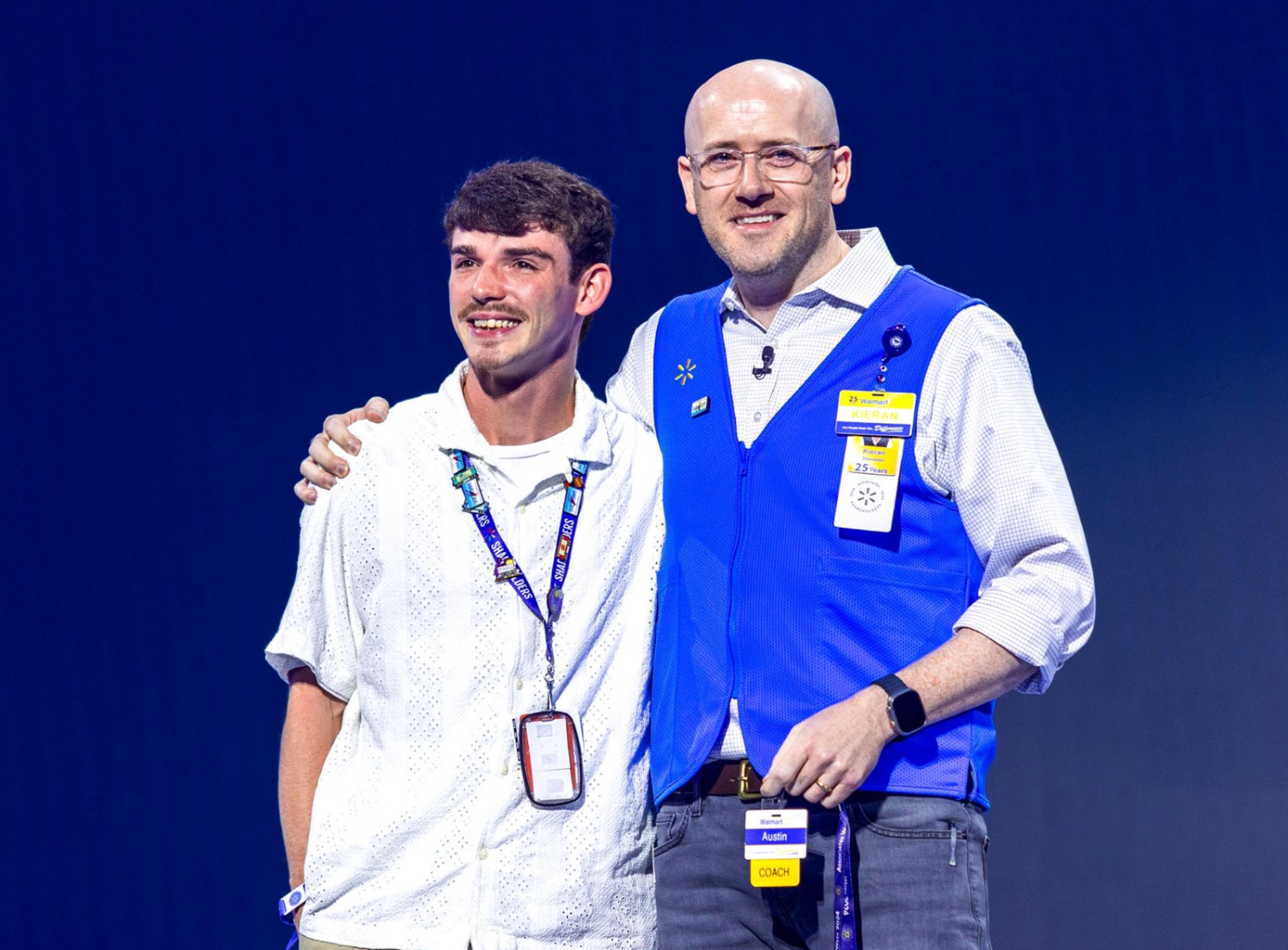 Kieran and associate on stage smiling