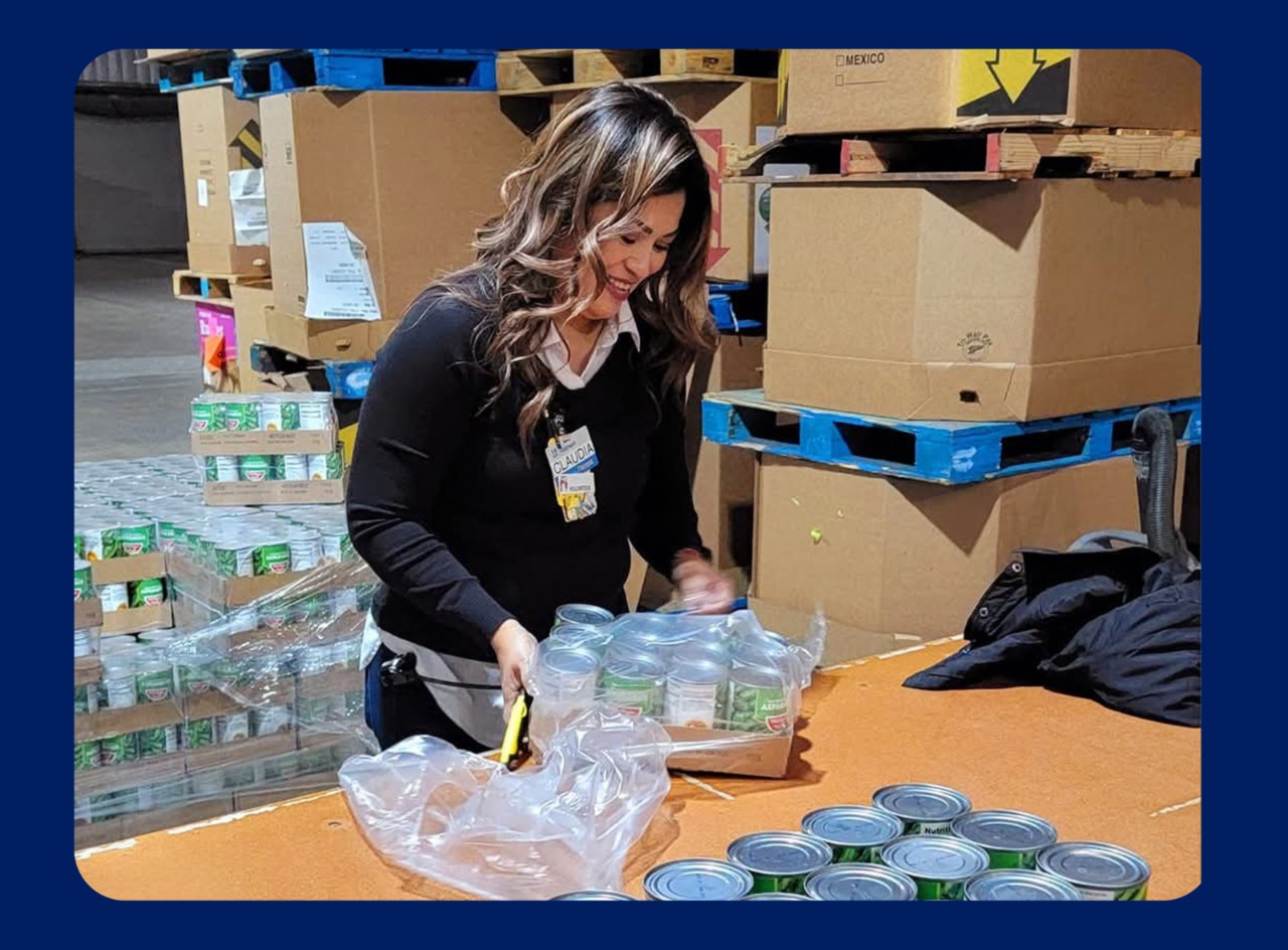 Walmart associate Claudia Zamudio unpacks canned goods for donations to Yuma Food Bank.