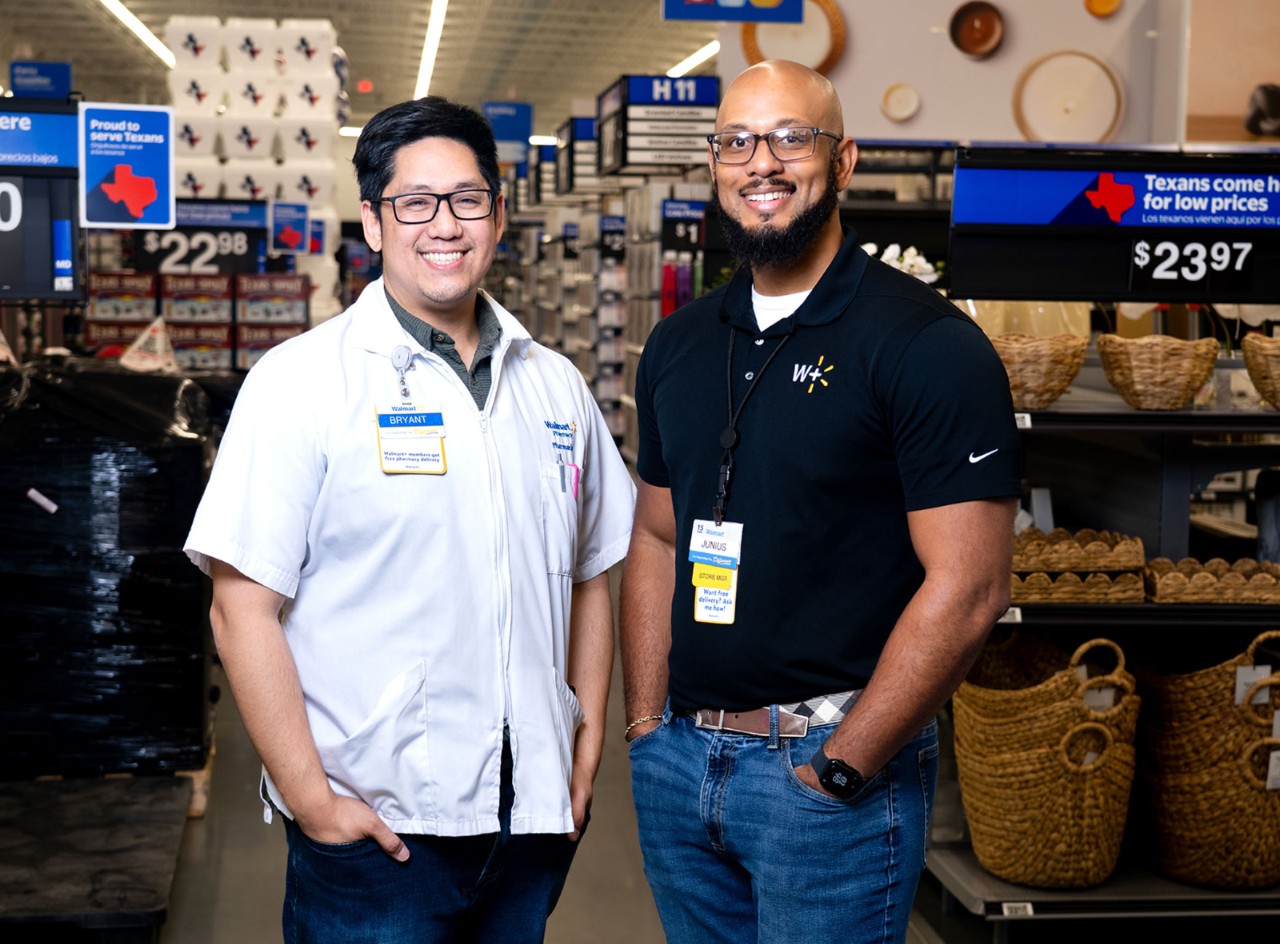 Walmart Pharmacy Manager Bryant Dao and Store Manager Junius Williams smile at camera.